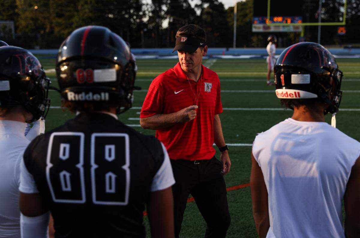 Nation Ford head coach Jake Bentley works with his team before their game against Richland Northeast.