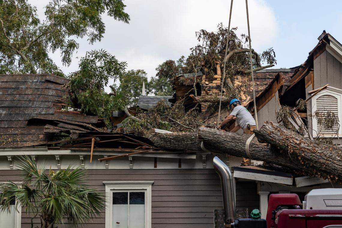 Workers remove a large Pecan tree from the roof of the house Chris Dunn and Lori Griffin rent in Newberry on Monday, Sept 30, 2024. “It sounded like a gravel truck,” Dunn said. As strong winds from Hurricane Helene knocked the tree down.
