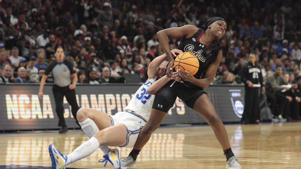 South Carolina's Raven Johnson (25) grapples with UCLA’s Angela Dugalić (32) for loose ball during the first half of action of their women's basketball game for the NCAA national championship against UCLA at Mortgage Matchup Center in Phoenix on Sunday, April 5,2026.