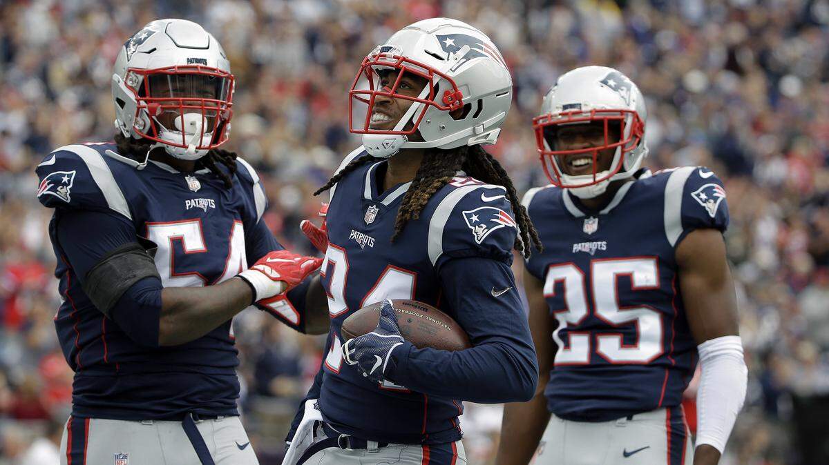 New England Patriots defensive back Stephon Gilmore, center, celebrates his interception with Dont’a Hightower, left, and Eric Rowe, right, during the first half of an NFL football game against the Houston Texans, Sunday, Sept. 9, 2018, in Foxborough, Mass. (AP Photo/Steven Senne)