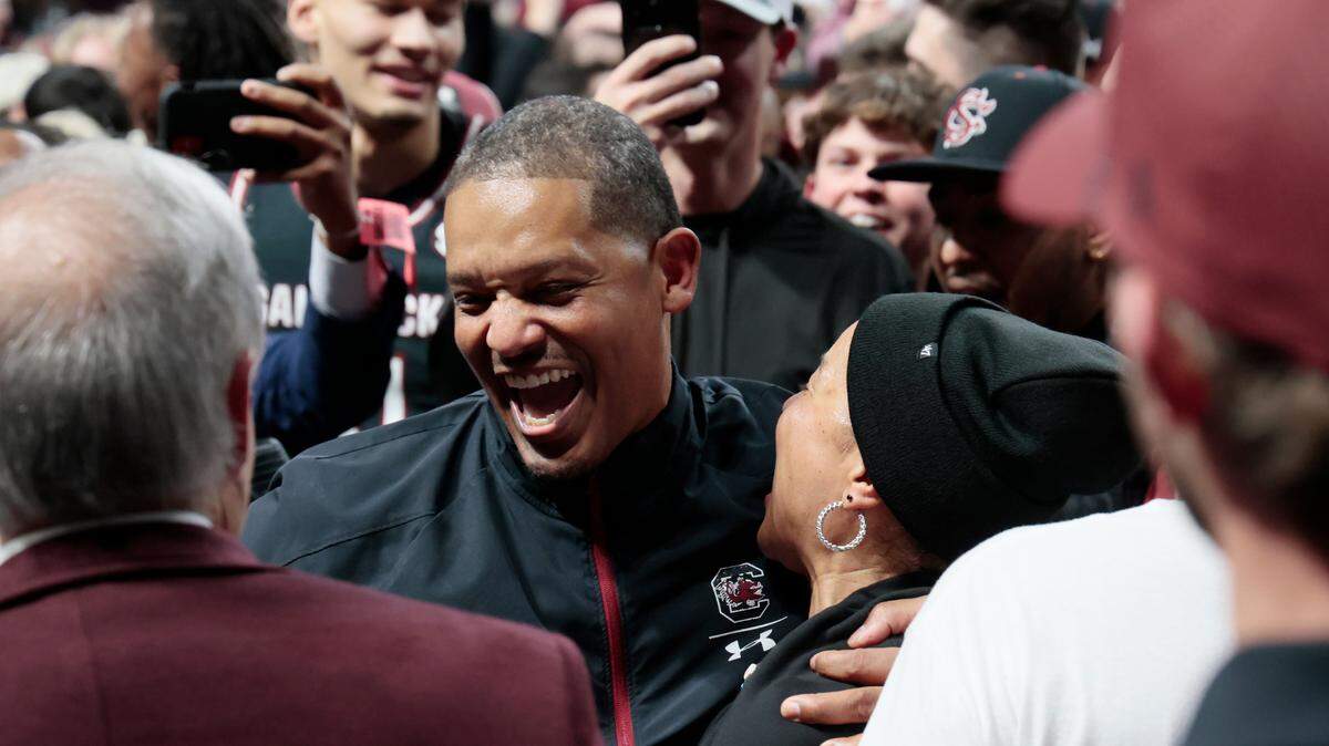South Carolina men’s basketball head coach Lamont Paris celebrates with women’s head coach Dawn Staley after beating Kentucky in Colonial Life Arena in Columbia, South Carolina on Tuesday, January 23, 2024.