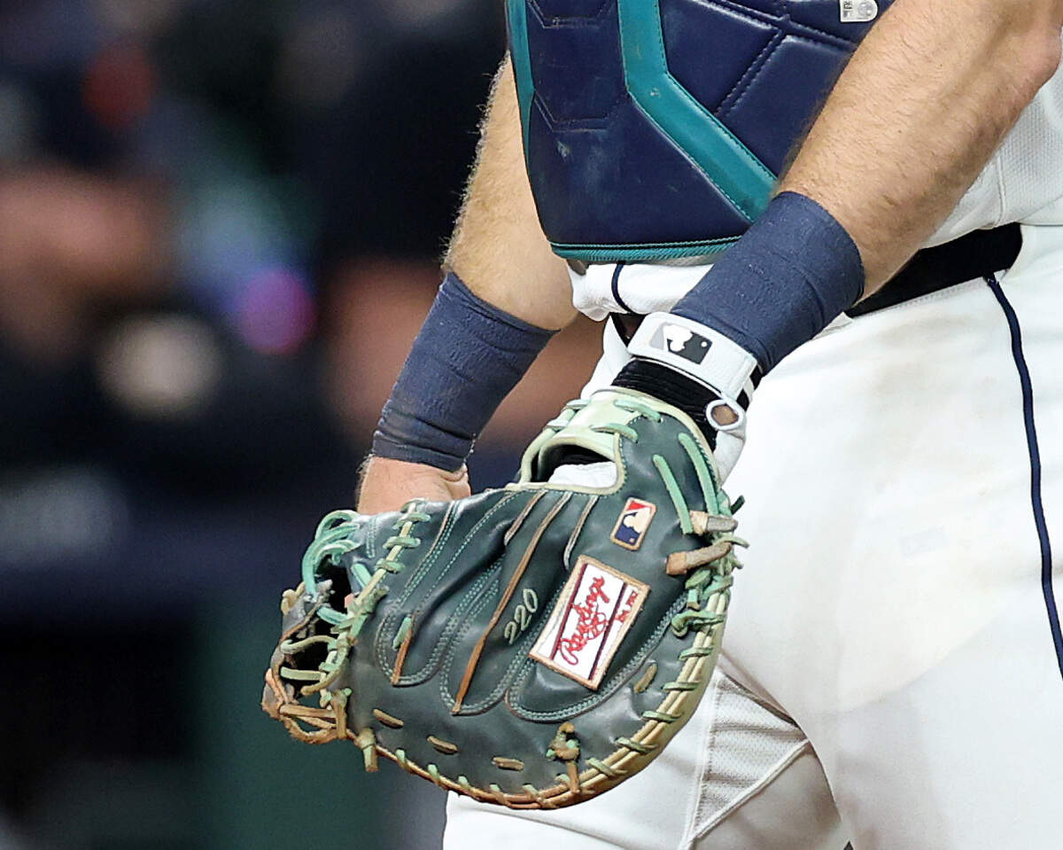 As seen in this zoomed-in photo from an Oct. 4 playoff game, Seattle Mariners catcher Cal Raleigh has the number 220 stitched into his custom catcher’s mitt, right above the Rawlings logo. It’s a little-known detail — and a hat tip to former Clemson baseball coach Jack Leggett.