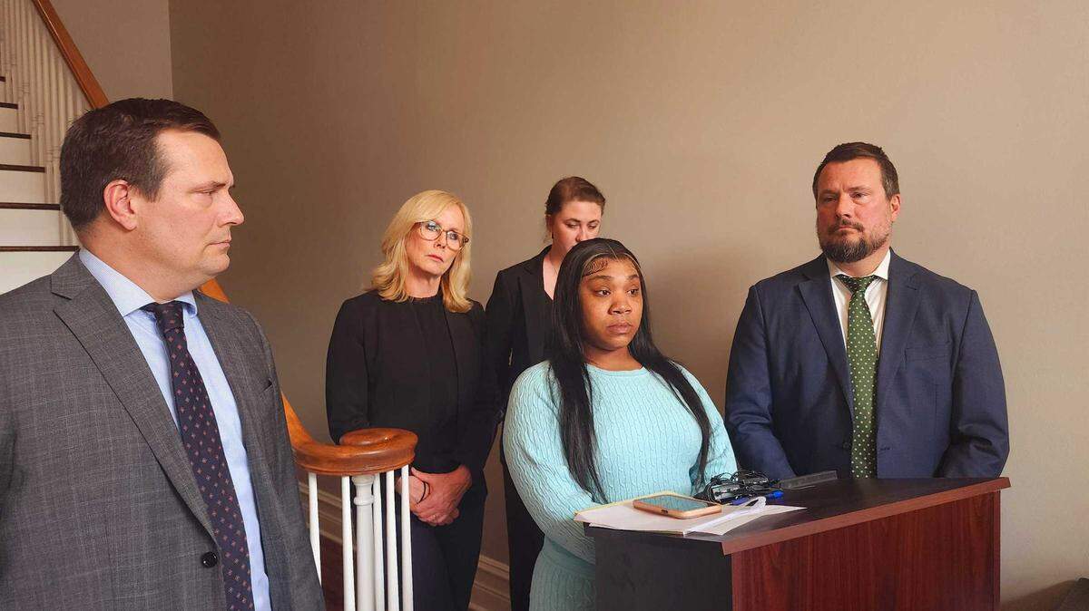 Taylor Ishmal stands with attorneys from the Shealey Law firm as she speaks with reporters after filing a lawsuit against the City of Columbia, the Columbia Police Department and former officer Caleb Hickmon-Payne for sexual assault on March 13, 2025.