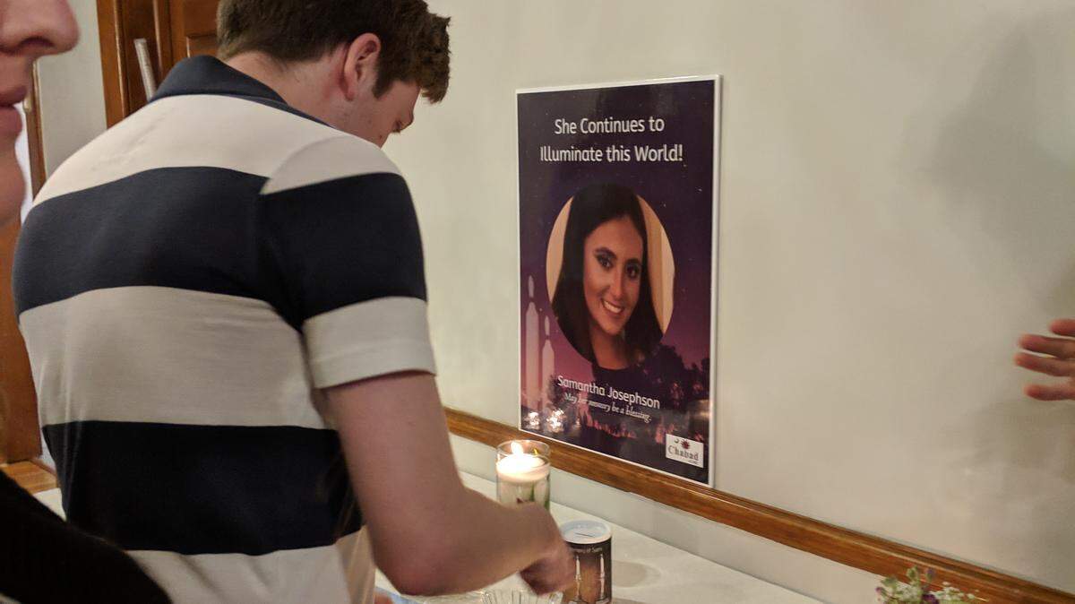 McKenzi Norris lights a Shabbat candle in honor of Samantha Josephson, whom police say was murdered last week after getting in a car she thought was her Uber.