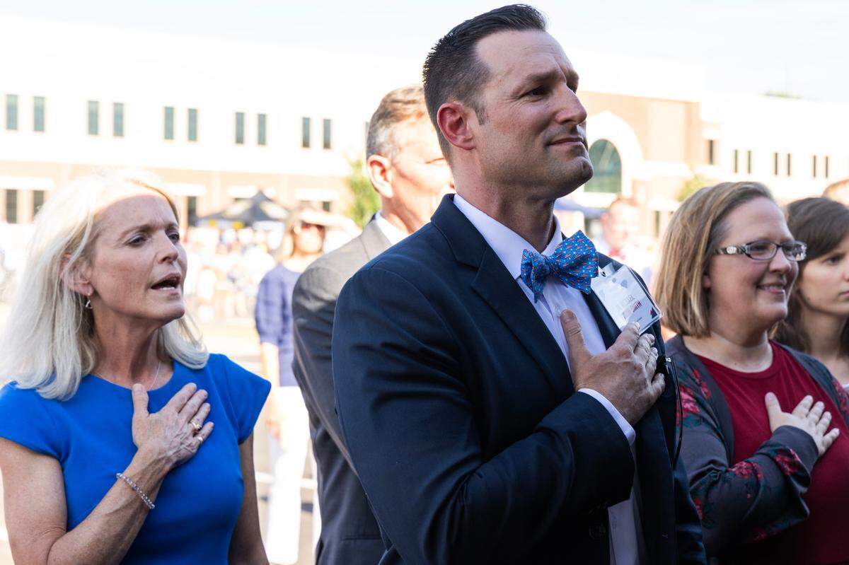 American Leadership Academy Lexington School Leader Michael Gordon Smith listens to the Pledge of Allegiance during a ceremony at the school’s grand opening on Thursday, August 10, 2023.