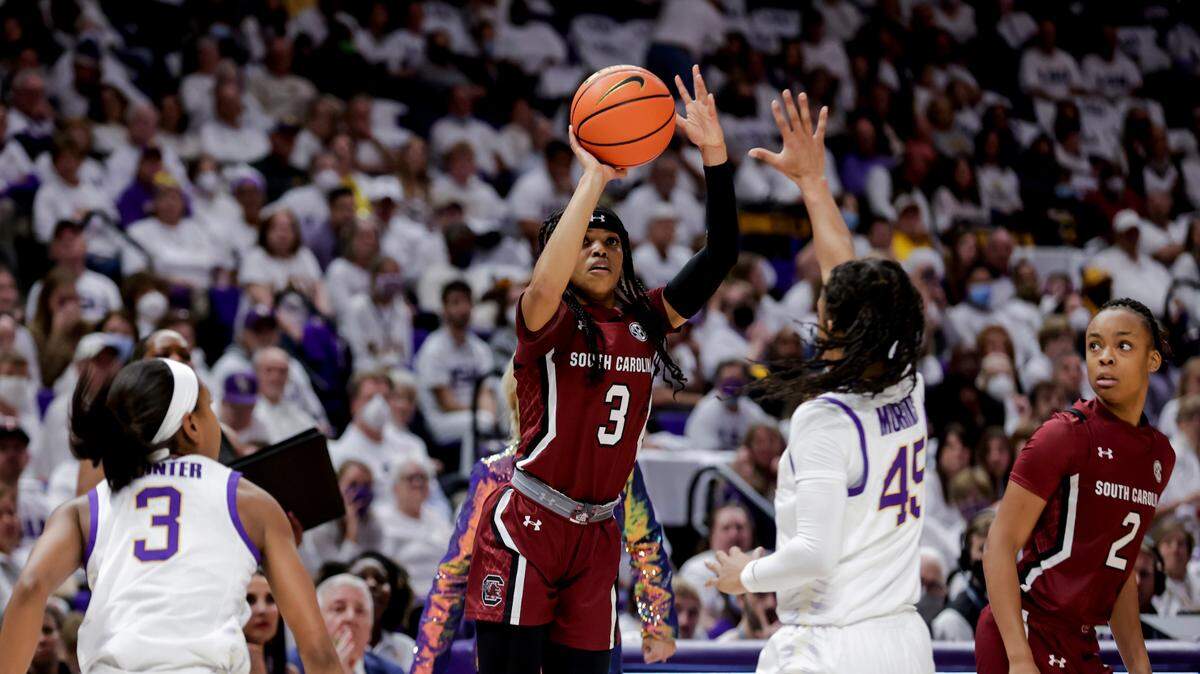 South Carolina guard Destanni Henderson (3) shoots as LSU guard Alexis Morris (45) and guard Khayla Pointer (3) defend during the first half of an NCAA college basketball game in Baton Rouge, La., Thursday, Jan. 6, 2022. (AP Photo/Derick Hingle)