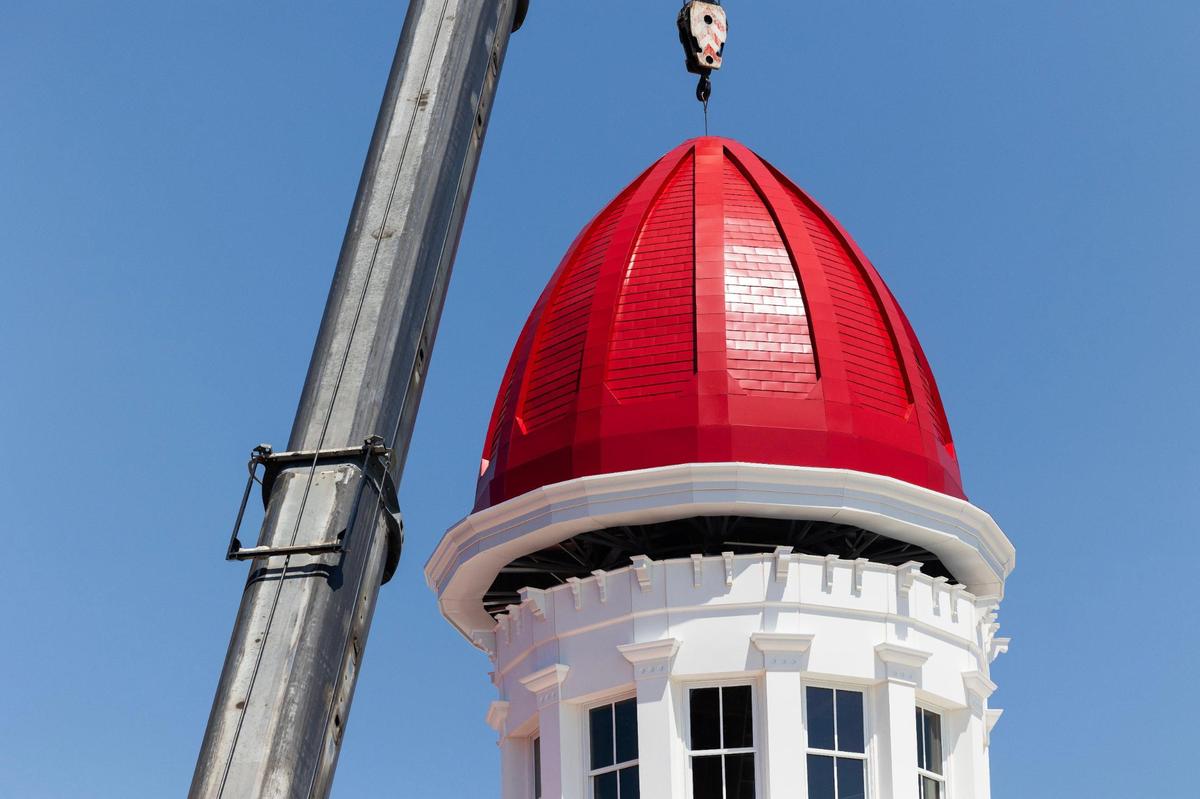 Workers install the new cupola dome at the Babcock building on Friday, August 18, 2023.