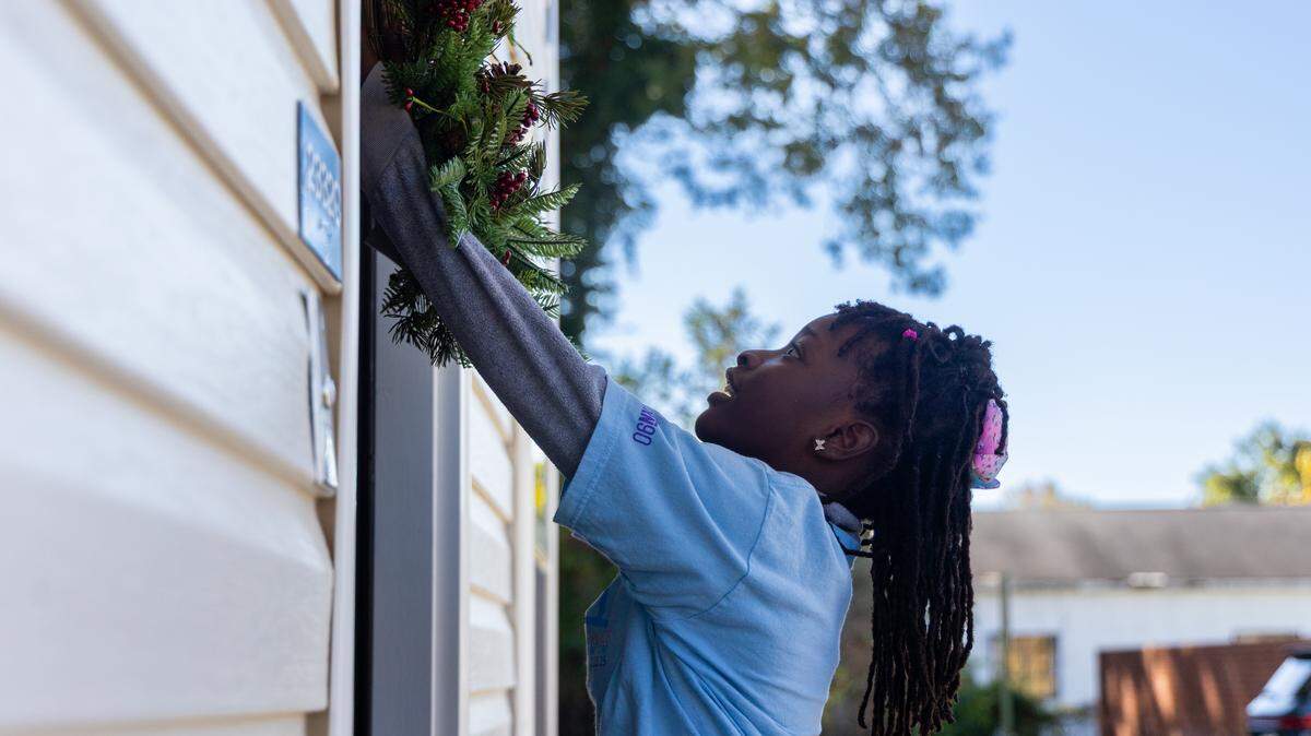 O’Nur, an 8-year-old resident of the Waites Way townhome development, welcomes her neighbors during an opening ceremony on Thursday, November 13, 2025. Homeless No More, a local nonprofit, worked with numerous agencies and donors to build the Waites Way community off Two Notch Road.