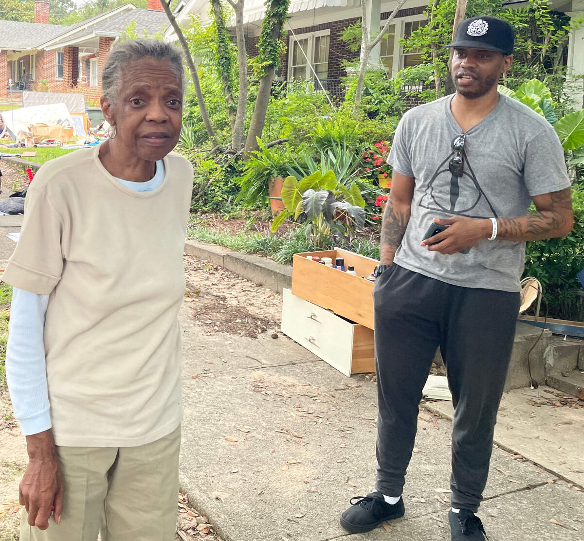 Elvira and Sean Kennedy stand near the house she lived in for almost 25 years before she was evicted in July.
