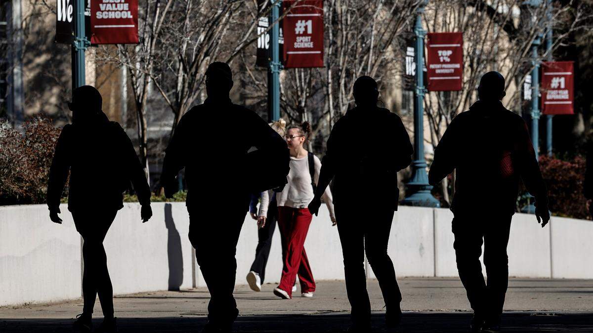Students walk across campus at the University of South Carolina in Columbia.