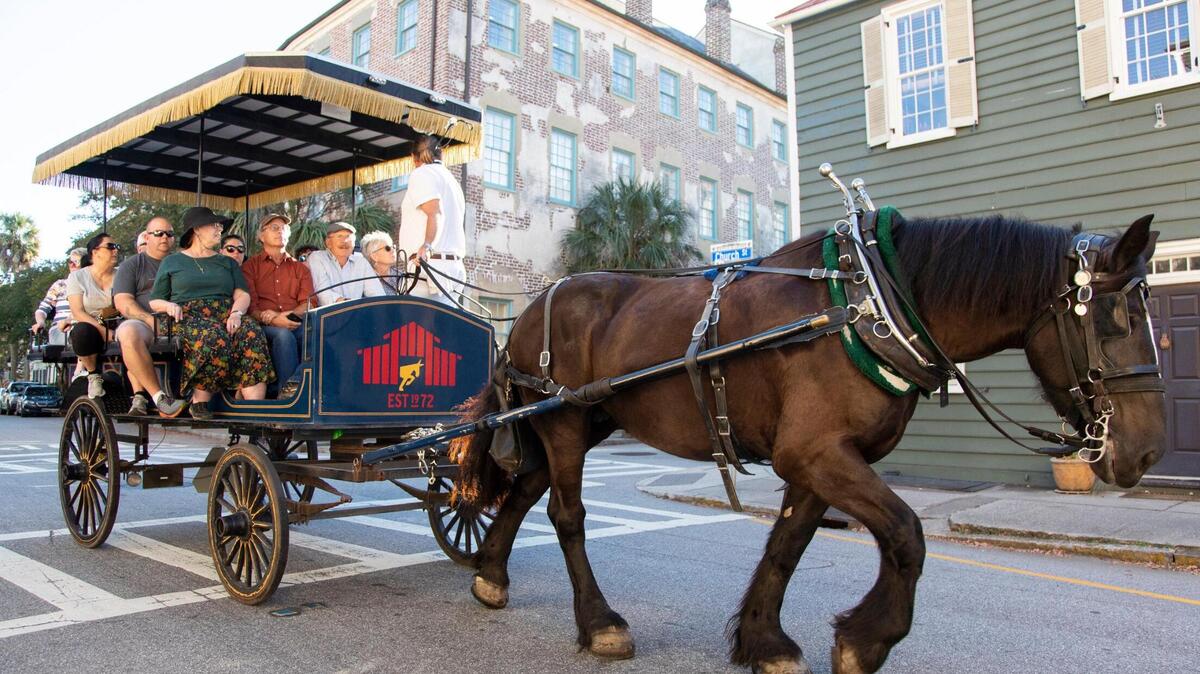 A horse-drawn carriage takes visitors on a tour in Charleston, South Carolina on Saturday, October 23, 2021. Much of Charleston’s tourism centers around its history.