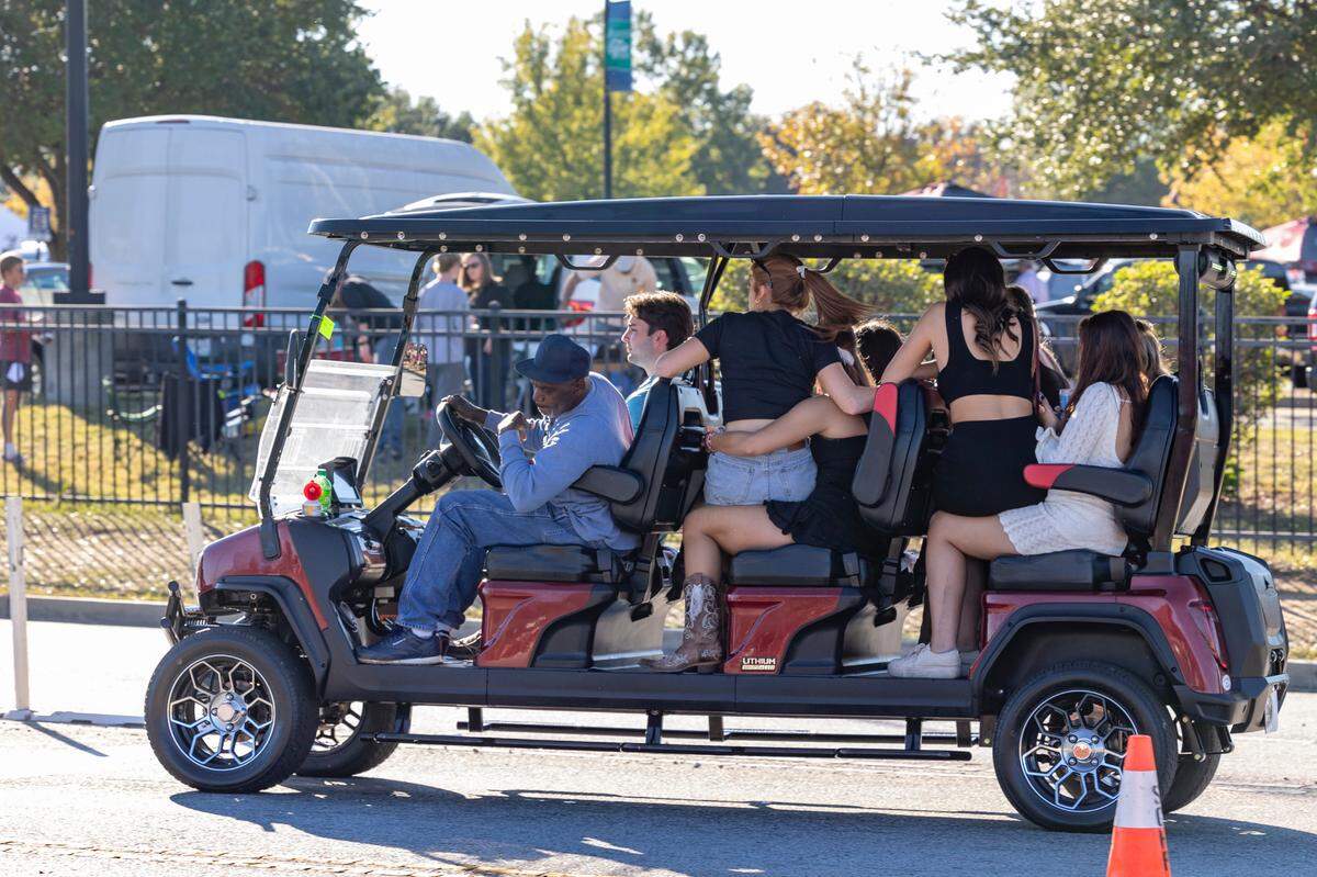 A golf cart taxi loaded with passengers makes its way to Williams-Brice Stadium before USC’s game against Missouri on Saturday, Nov. 16, 2024
