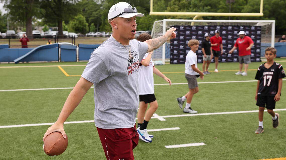 South Carolina quarterback Spencer Rattler works with kids attending the Spencer Rattler FlexWork Football Camp at Dreher High School in Columbia on Saturday, May 20, 2023.