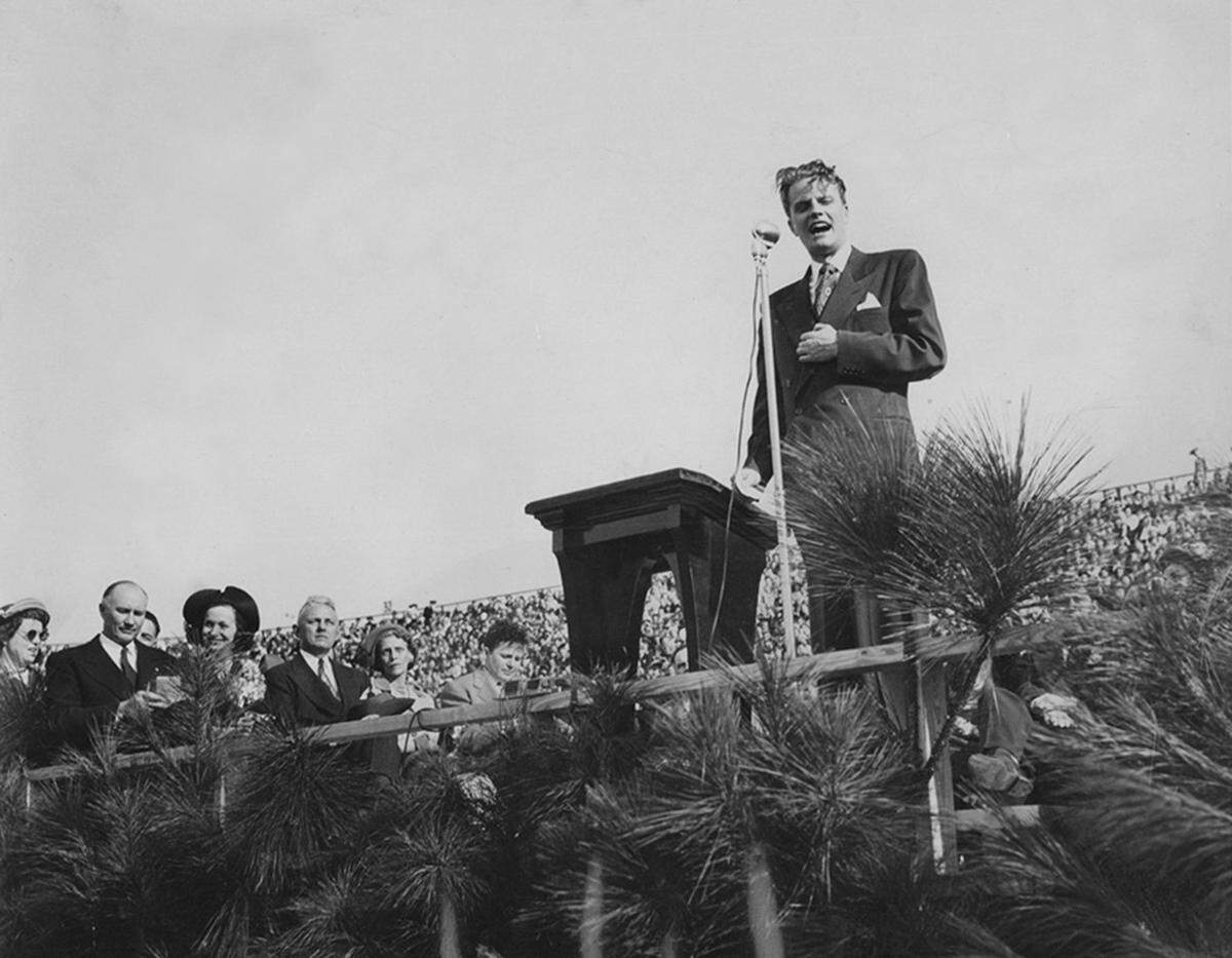 Rev. Billy Graham speaks during his crusade at USC Stadium in 1950.