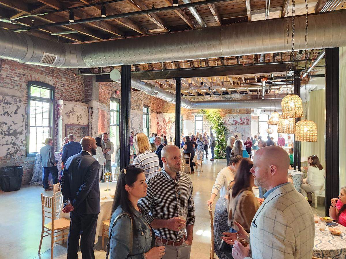 People gather on April 9, 2025 at the grand opening of The Laundry, a new event space venue in the BullStreet District.