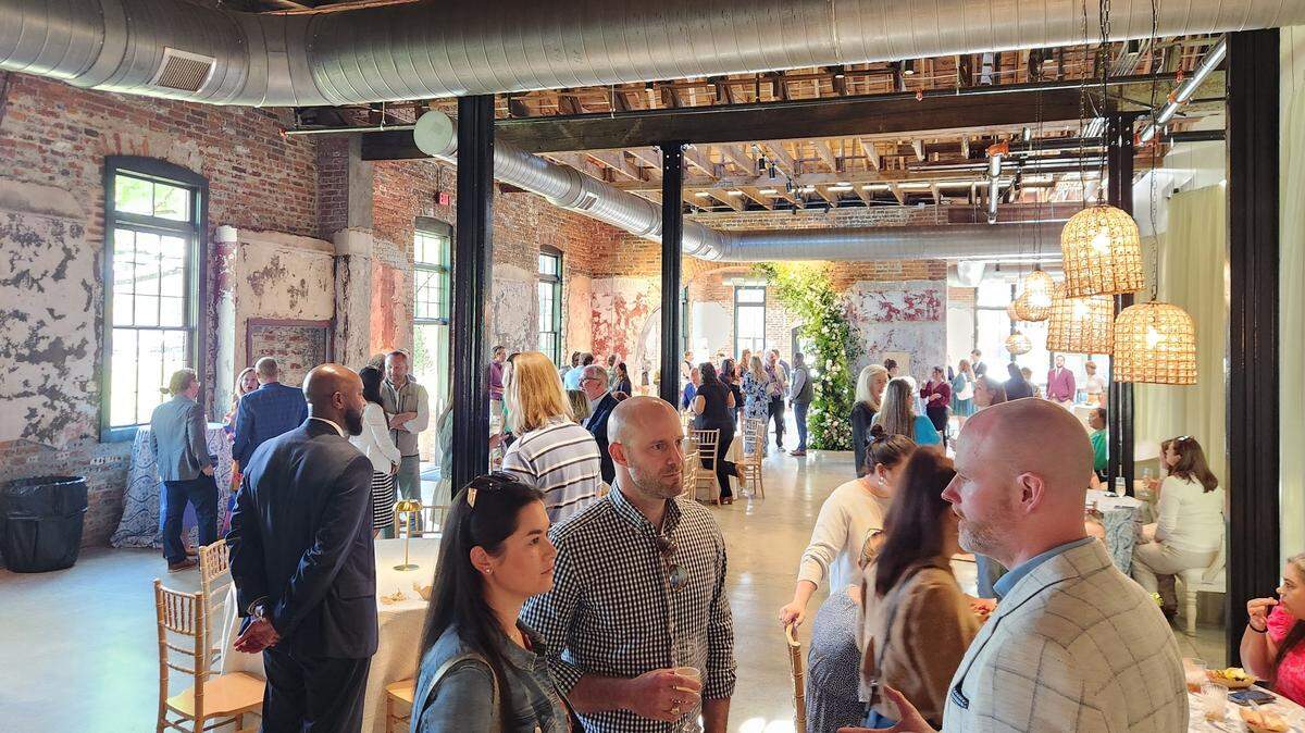 People gather on April 9, 2025 at the grand opening of The Laundry, a new event space venue in the BullStreet District.