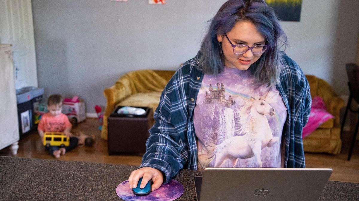 Caroline Turner works on school work at her home on Thursday, March 25, 2021. Turner had worked as a bartender and dog groomer before becoming a stay-at-home mom, and wants a more lucrative career as a software engineer once her kids are old enough to go to school.