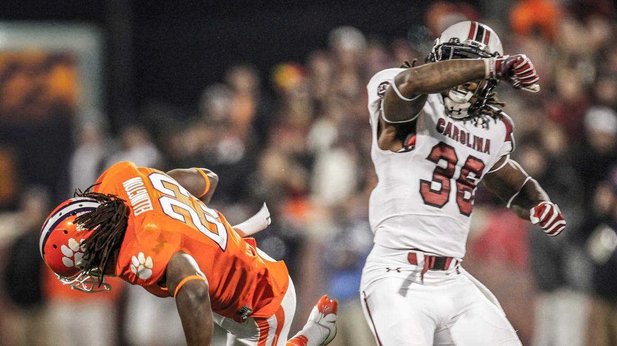 South Carolina’s D.J. Swearinger lays out Clemson’s Andre Ellington in Clemson, S.C. on Nov. 24, 2012.