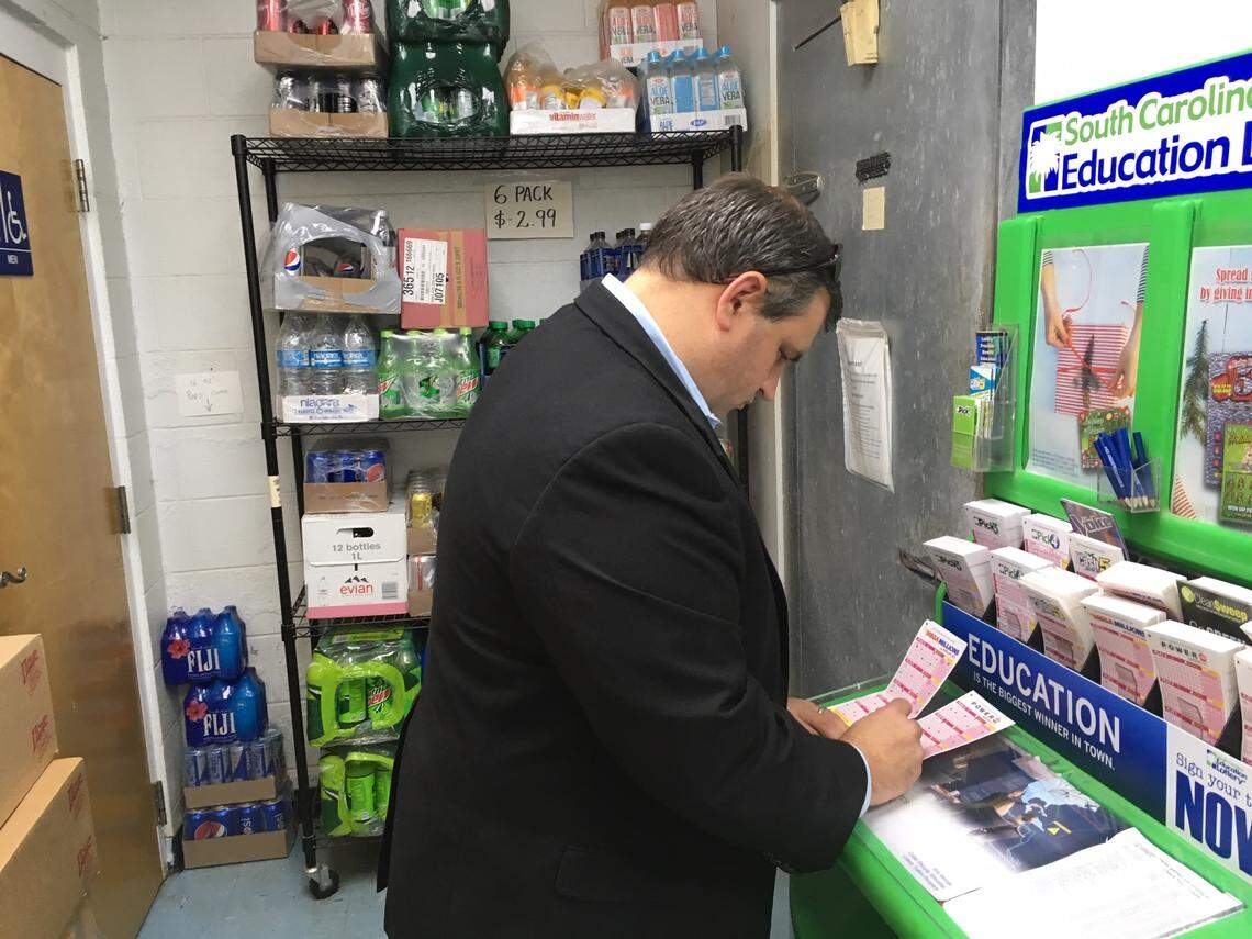 Micah Valentine fills out a Mega Millions ticket at KC Mart No. 7 in Simpsonville. The winning ticket in Tuesday’s $1.5 billion Mega Millions jackpot was sold at the store.
