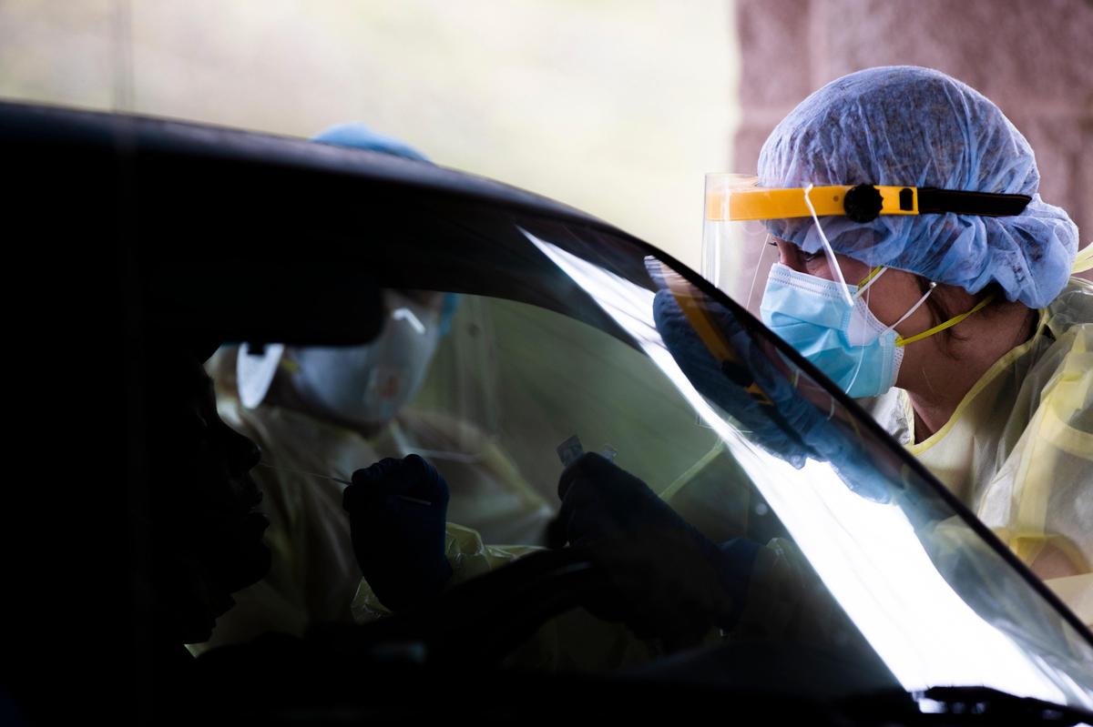 A nurse with the Sandhills Medical Foundation tests a patient for the coronavirus at the Kershaw Mental Health Clinic in Camden, South Carolina on Monday, March 23, 2020. Before testing for the coronavirus, nurses perform rapid tests for strep throat and the flu. If both of those are negative, then nurses test for the coronavirus.