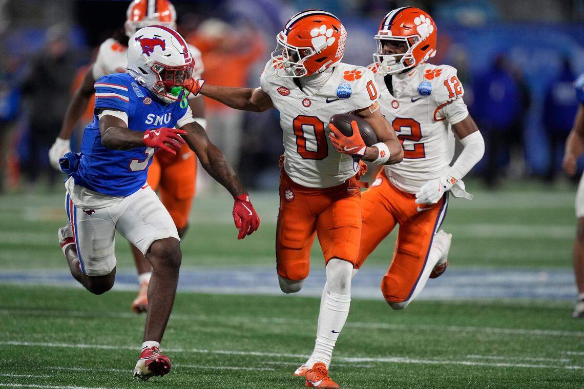Dec 7, 2024; Charlotte, NC, USA; Clemson Tigers wide receiver Antonio Williams (0) runs against Southern Methodist Mustangs safety Ahmaad Moses (3) during the third quarter in the 2024 ACC Championship game at Bank of America Stadium.