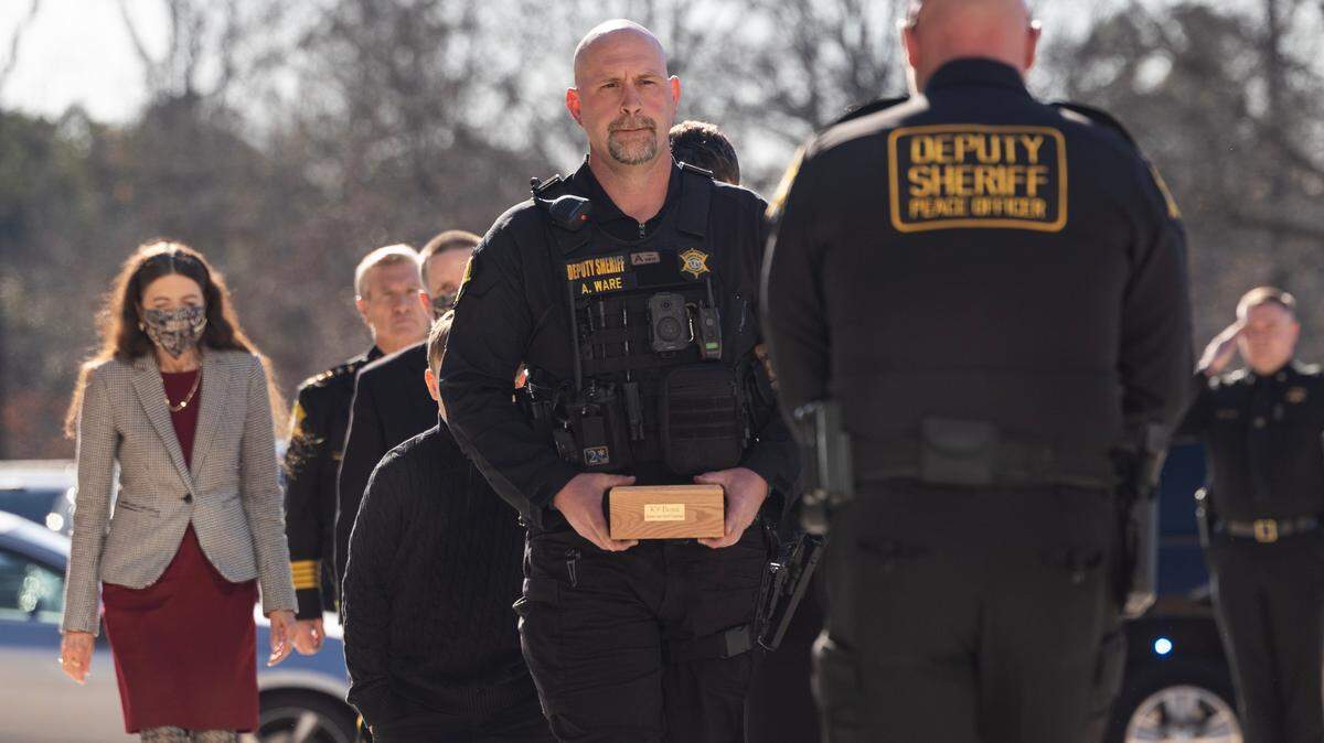 Richland County Sheriffs Department K9 Specialist Alan Ware carries the ashes of his K9 partner Bumi, who died while pursuing a teenage suspect on December 23, 2024.