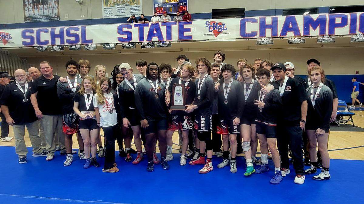 Gilbert wrestling poses with the runner-up trophy at the Class 3A wrestling championship on Feb. 10, 2024.