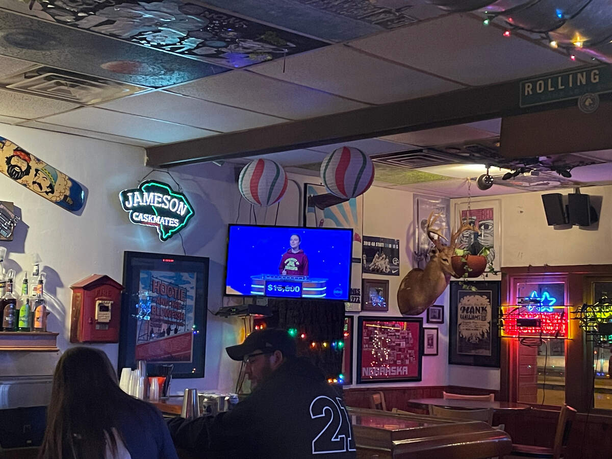 Patrons of Bar None watch Dutch Fork High School graduate Emmey Harris compete in the National College Championship of Jeopardy.