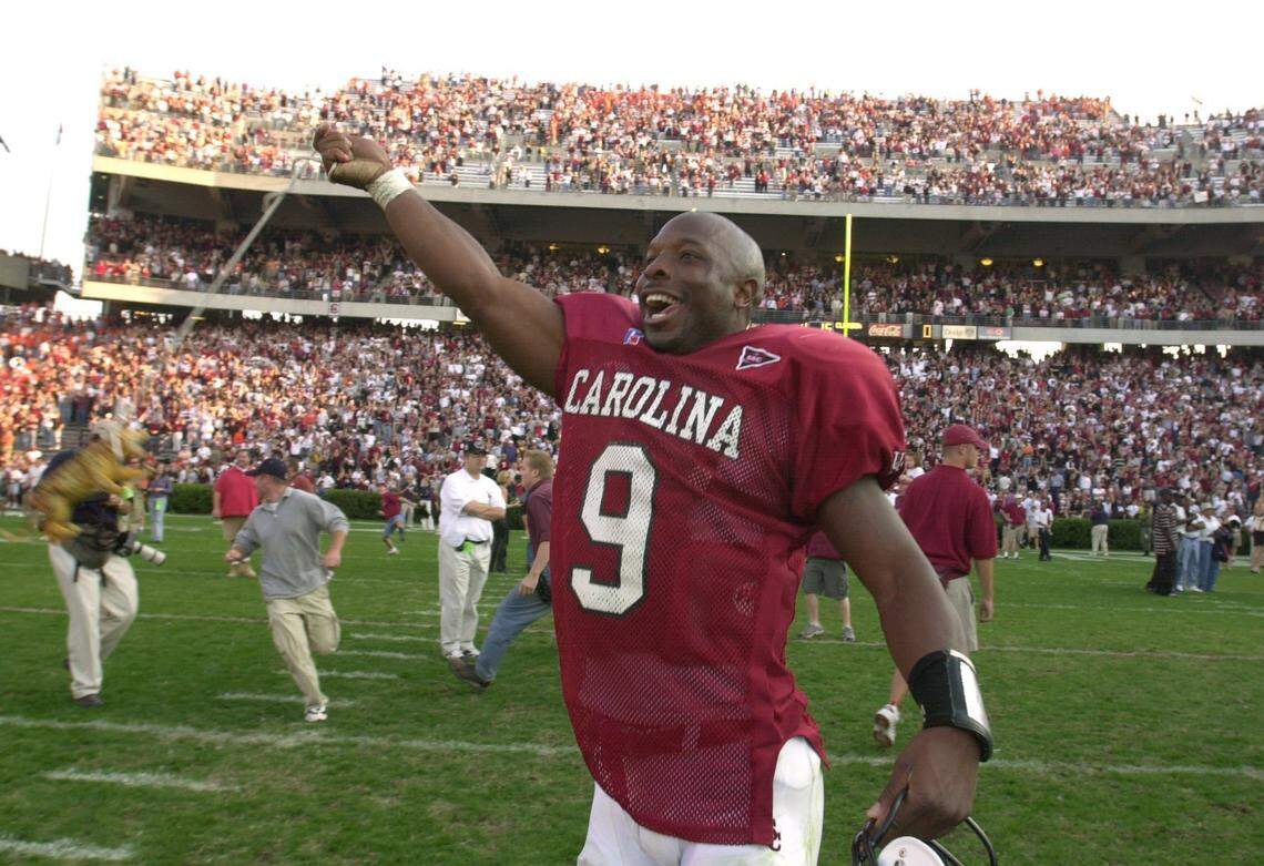 Former South Carolina quarterback Corey Jenkins celebrates after helping USC defeat Clemson 20-15 in 2001. Jenkins was named the new football coach at Dreher High School.