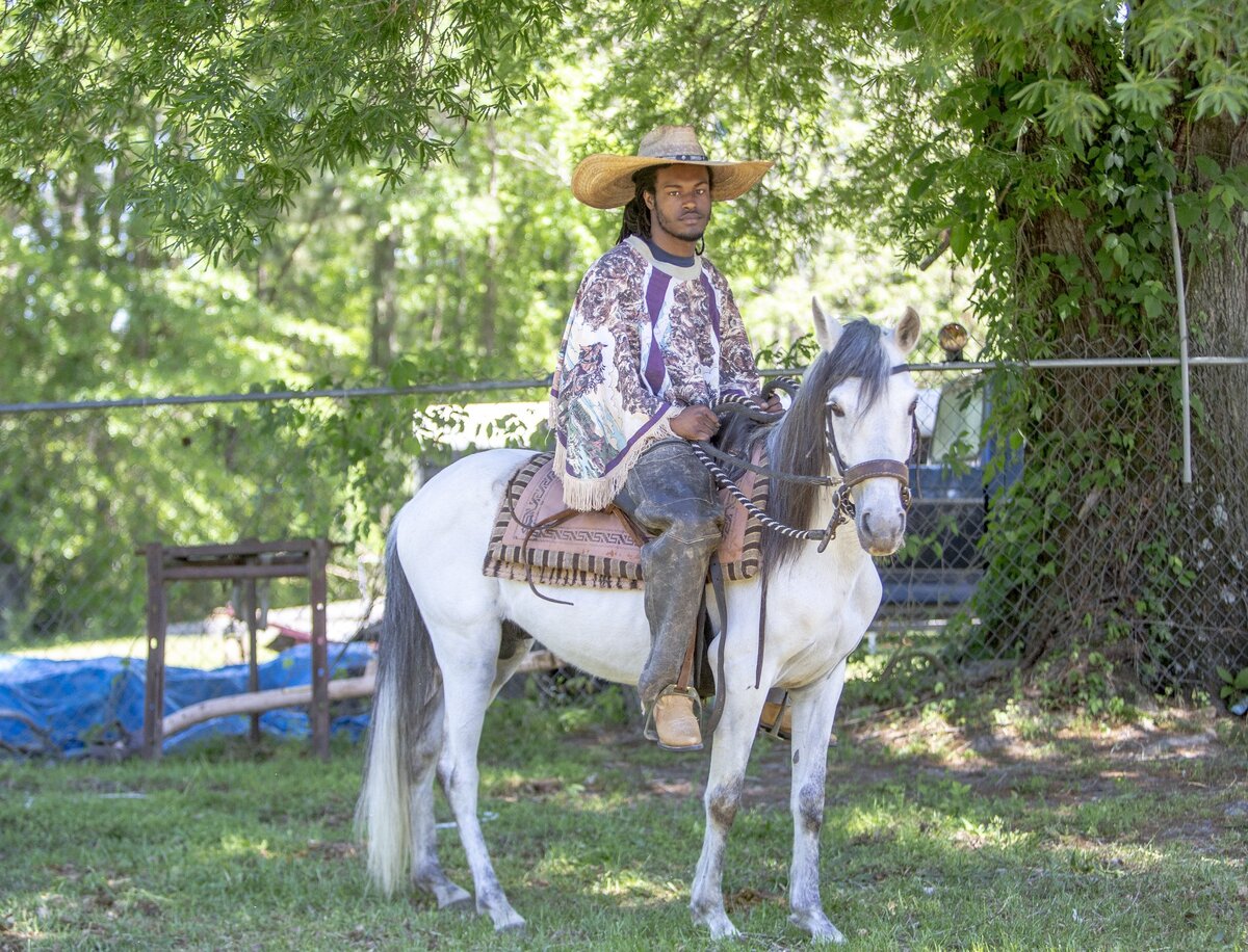 Tyrese Gray, 17, sits on Ginuwine, an 8-year-old Paso Fino, on his uncle’s ranch in Prosperity, SC. Gray began riding at 5 years old when his uncle, Danny Wilson, put him on a horse and taught him to ride. “It feels free,” said Gray about riding horses.