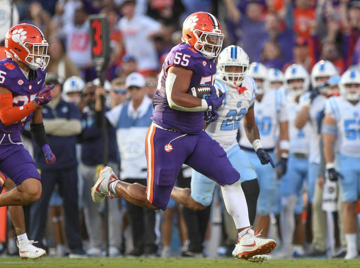 Nov 23, 2024; Clemson, South Carolina, USA; Clemson Tigers defensive tackle Payton Page (55) returns an interception for a touchdown against The Citadel Bulldogs during the first quarter at Memorial Stadium. Mandatory Credit: Ken Ruinard-Imagn Images
