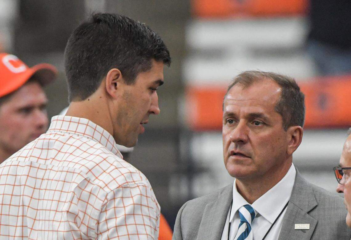 Sep 30, 2023; Syracuse, New York, USA; Clemson Tigers athletic director Graham Neff, left, and ACC Commissioner Jim Phillips talk before the game with the Syracuse Orange at JMA Wireless Dome.