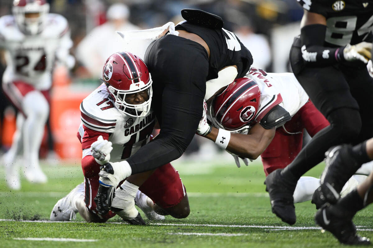 Nov 9, 2024; Nashville, Tennessee, USA; South Carolina Gamecocks linebacker Demetrius Knight Jr. (17) and linebacker Debo Williams (0) tackles Vanderbilt Commodores running back Sedrick Alexander (28) during the first half at FirstBank Stadium. Mandatory Credit: Steve Roberts-Imagn Images