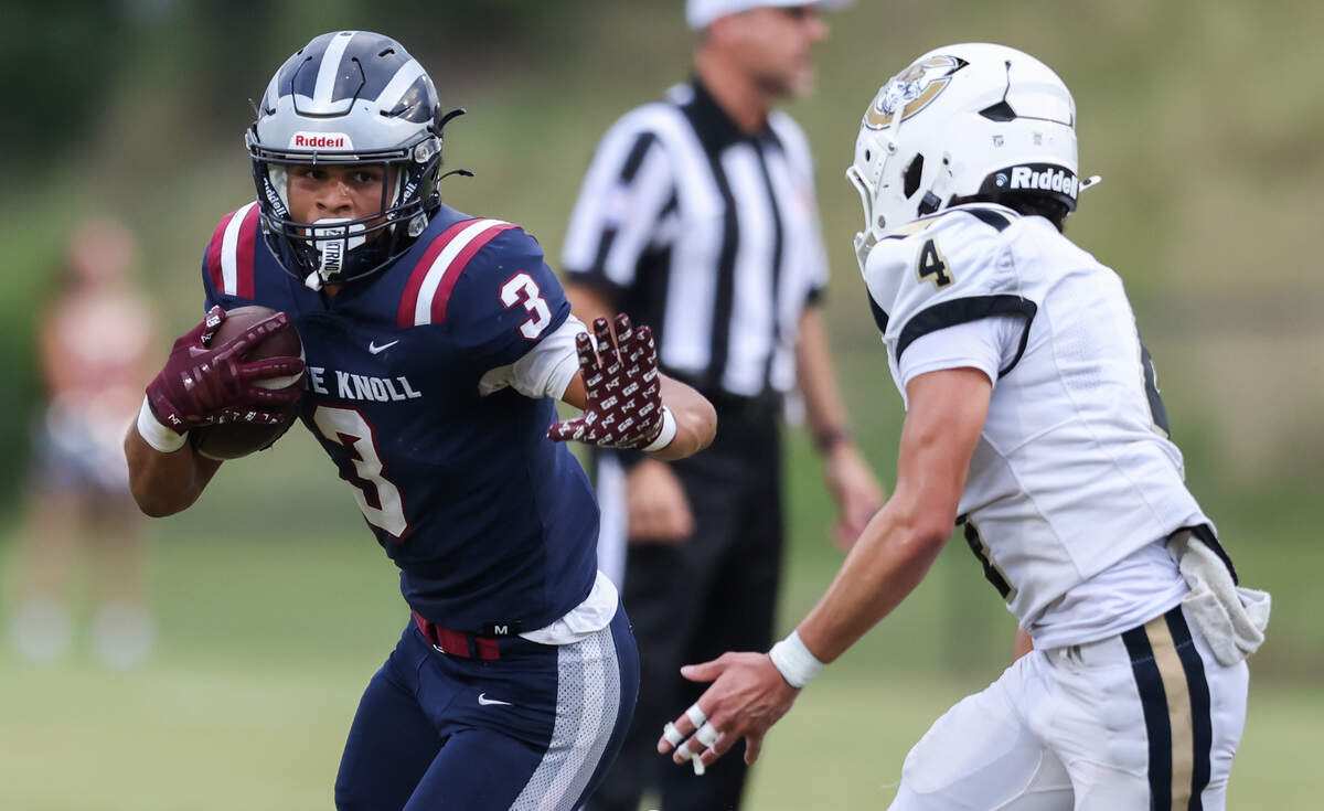 Tiyon Fanning (3) of White Knoll fends off the tackle of Evan Presbot of Camden during White Knoll’s game against Camden in Lexington on Thursday, Aug. 21, 2025.