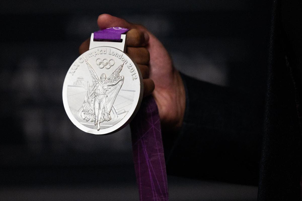 University of South Carolina’s Jason Richardson, a former Gamecocks track and field star, shows his silver metal before he is inducted into the university’s hall of fame at Williams-Brice Arena on Friday, November 1, 2024.