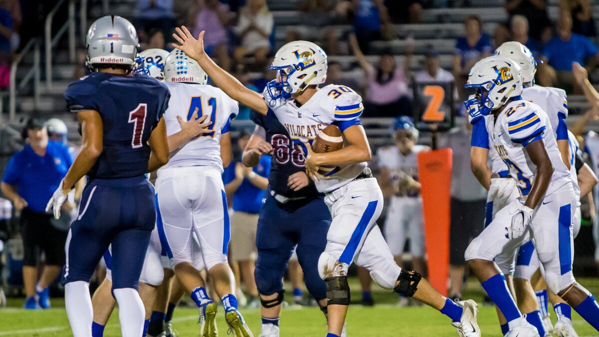 Lexington Wildcats Taylor Mathias (30) celebrates a fumble recovery during the game between Lexington High School at White Knoll High School.