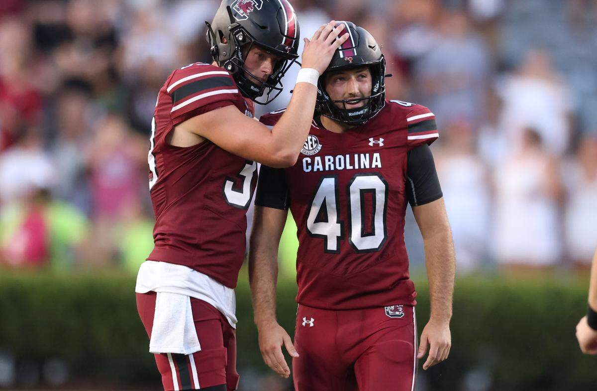 South Carolina punter Kai Kroeger (39) pats place kicker Alex Herrera (40) on the head following a missed field goal during the second half of the Gamecocks’ season opener against Old Dominion in Columbia on Saturday, August 31, 2024.