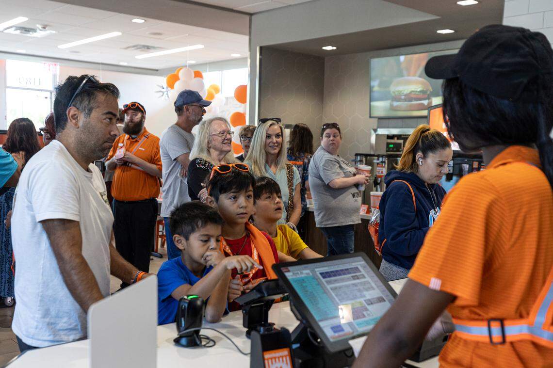 Christian Bonilla and his sons, Alex, 7, Benjamin, 10, and Ezra, 9, order during the grand opening of the Whataburger in Irmo on Monday, Sept. 9, 2024. The Bonilla family moved from Ft. Worth, Texas so they were familiar with the chain and were excited to come to the opening.