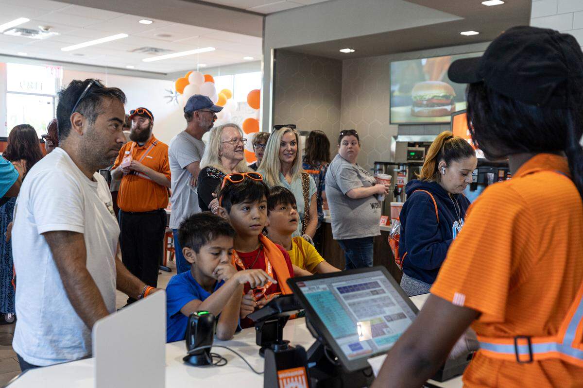 Christian Bonilla and his sons, Alex, 7, Benjamin, 10, and Ezra, 9, order during the grand opening of the Whataburger in Irmo on Monday, Sept. 9, 2024. The Bonilla family moved from Ft. Worth, Texas so they were familiar with the chain and were excited to come to the opening.