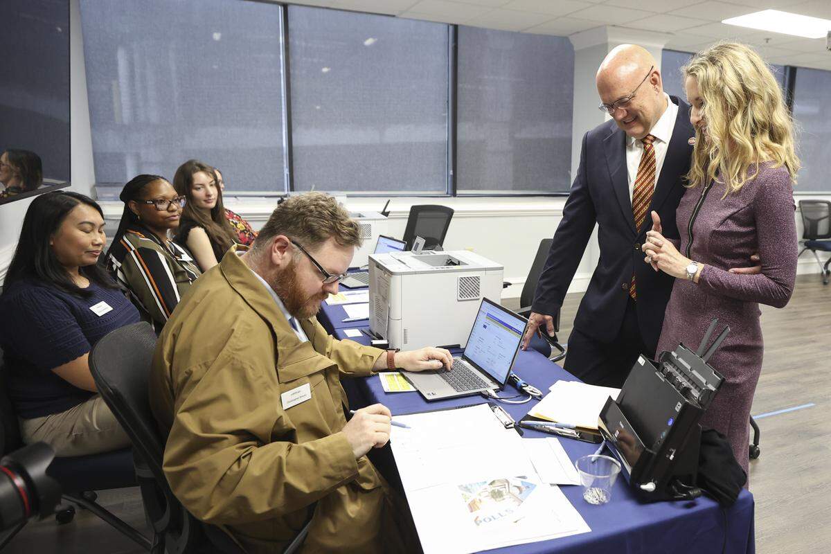 Christopher Shealy helps Mark Smith, with this wife, Elayne Smith, file for Congress at the South Carolina Election Commission on Monday, March 16, 2026.