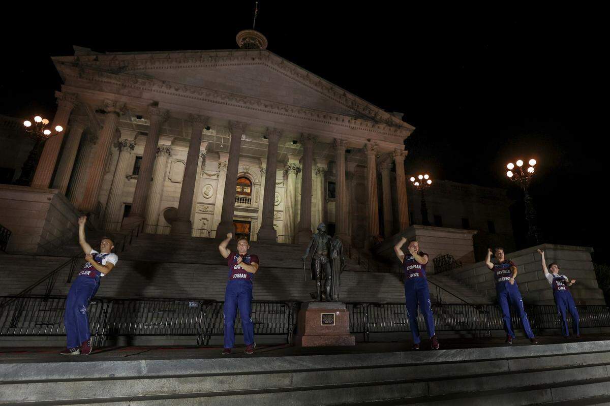 Yell leaders lead Texas A&M fans in the Aggie Yell practice in front of the South Carolina State House on Friday, Nov. 1, 2024. The Gamecocks face the Aggies Saturday at Williams-Brice Stadium.