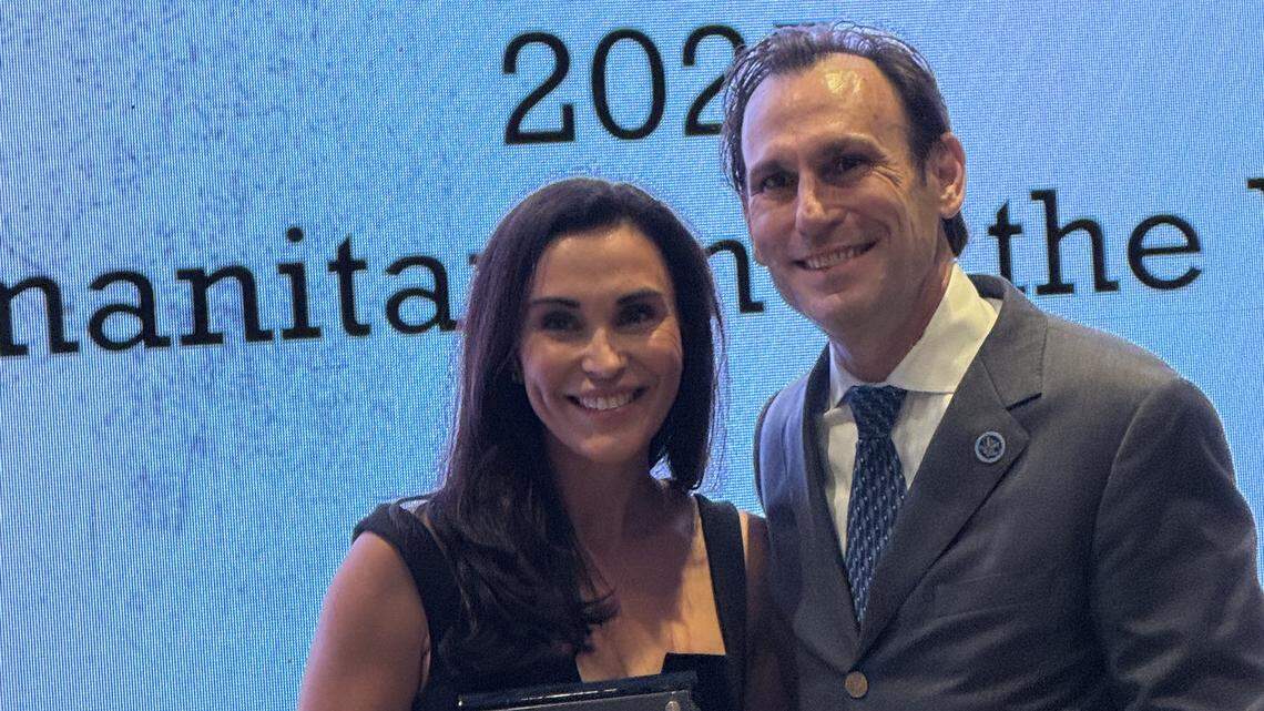 Emily Beamer, wife of South Carolina football coach Shane Beamer, poses with South Carolina Football Hall of Fame board chairman/president David Wyatt after receiving the organization’s 2025 Humanitarian of the Year Award on April 16, 2026 at Hotel Hartness in Greenville.