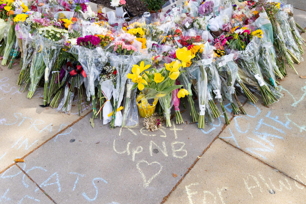 South Carolina students leave messages and flowers at a memorial for South Carolina student Nate Baker, who died after a hit-and-run crash on the intersection of Blossom Street and Assembly Street on Friday, April 4, 2025.
