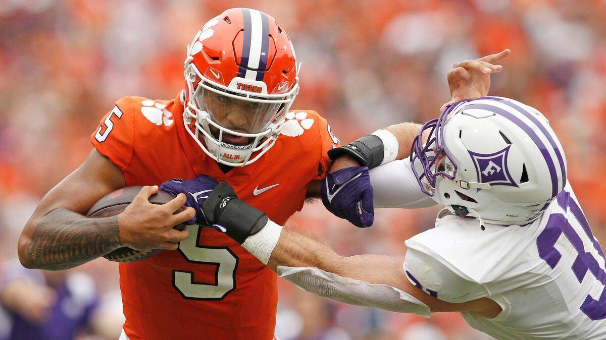 Clemson quarterback DJ Uiagalelei (5) gets around Furman linebacker Bryce McCormick (31) during second-quarter action in Clemson, S.C. on Saturday, Sept. 10, 2022.