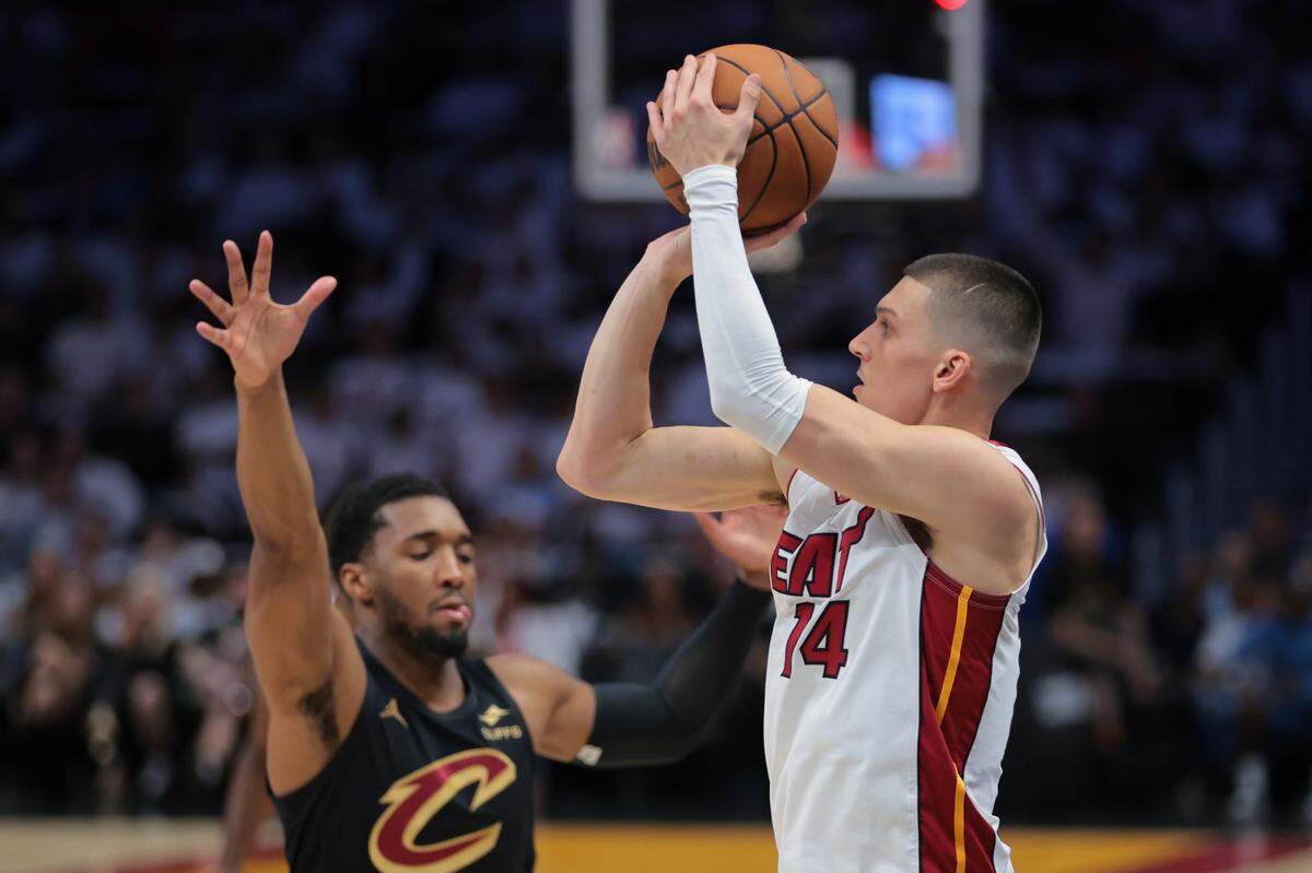 Apr 28, 2025; Miami, Florida, USA; Miami Heat guard Tyler Herro (14) shoots the basketball over Cleveland Cavaliers guard Donovan Mitchell (45) in the first quarter during game four for the first round of the 2025 NBA Playoffs at Kaseya Center.