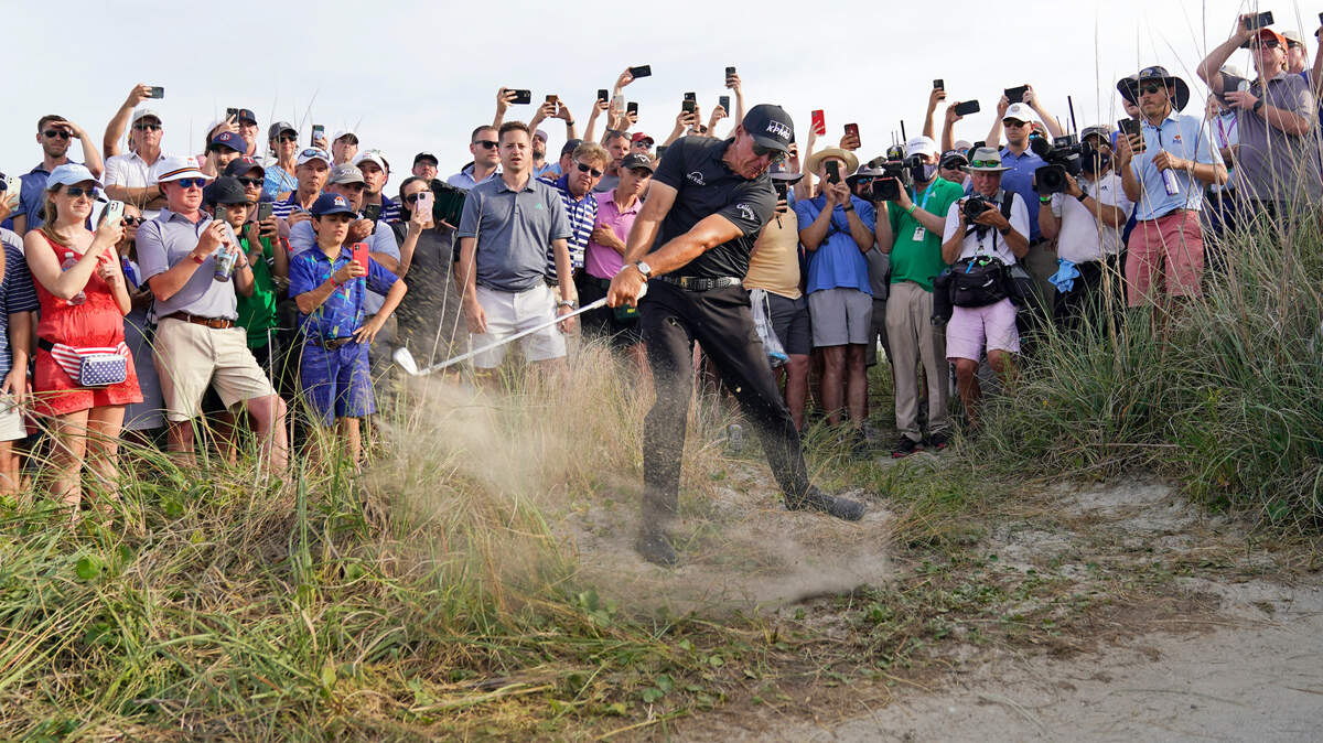 Phil Mickelson hits his second shot on the 16th hole from the rough during the third round at the PGA Championship golf tournament on the Ocean Course on Saturday.