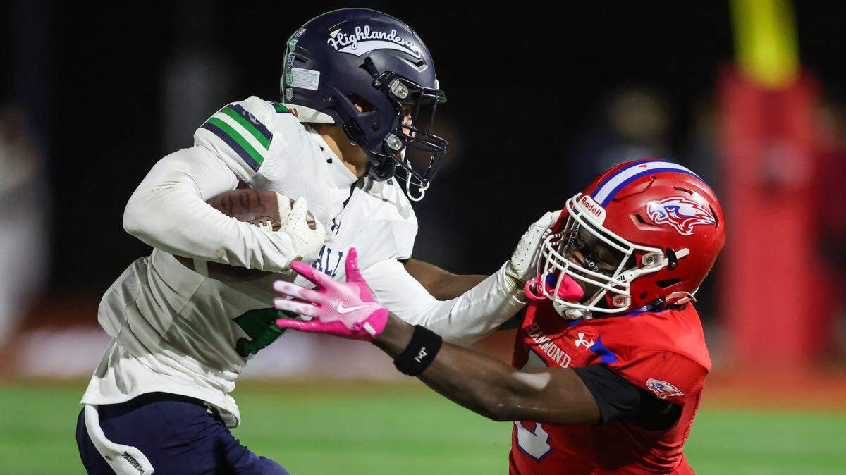 Jackson Noble (4) of Heathwood Hall fends off the tackle of Kanye Reed (8) of Hammond during Hammond’s game against Heathwood Hall at Hammond on Friday, Nov. 14, 2025.


