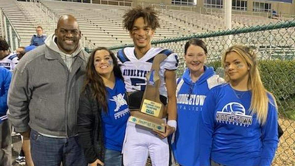 Middletown quarterback and South Carolina commit Braden Davis poses for a photo with his family after the Cavaliers defeated Smyrna for Delaware Class 3A title on Dec. 11, 2021.
