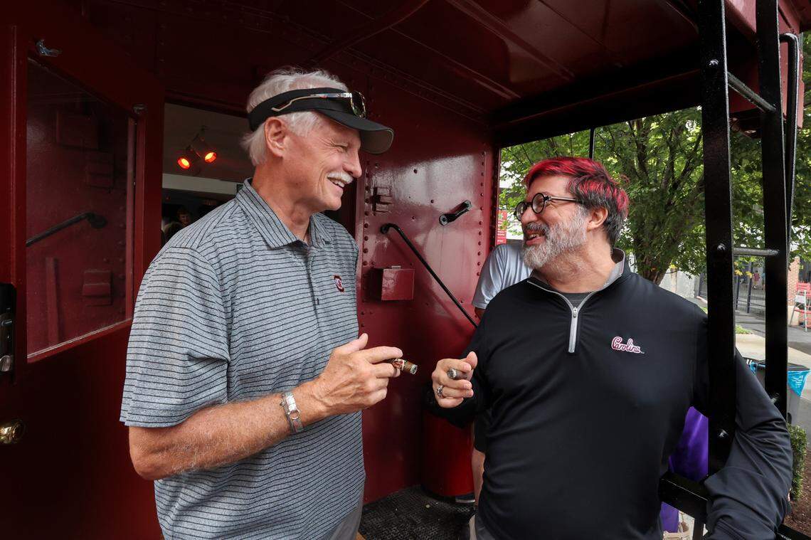 Ron Woodcock, left, and Eric Duncan enjoy cigars outside a Cockaboose before the USC game against LSU on Saturday, Sept. 14, 2024.