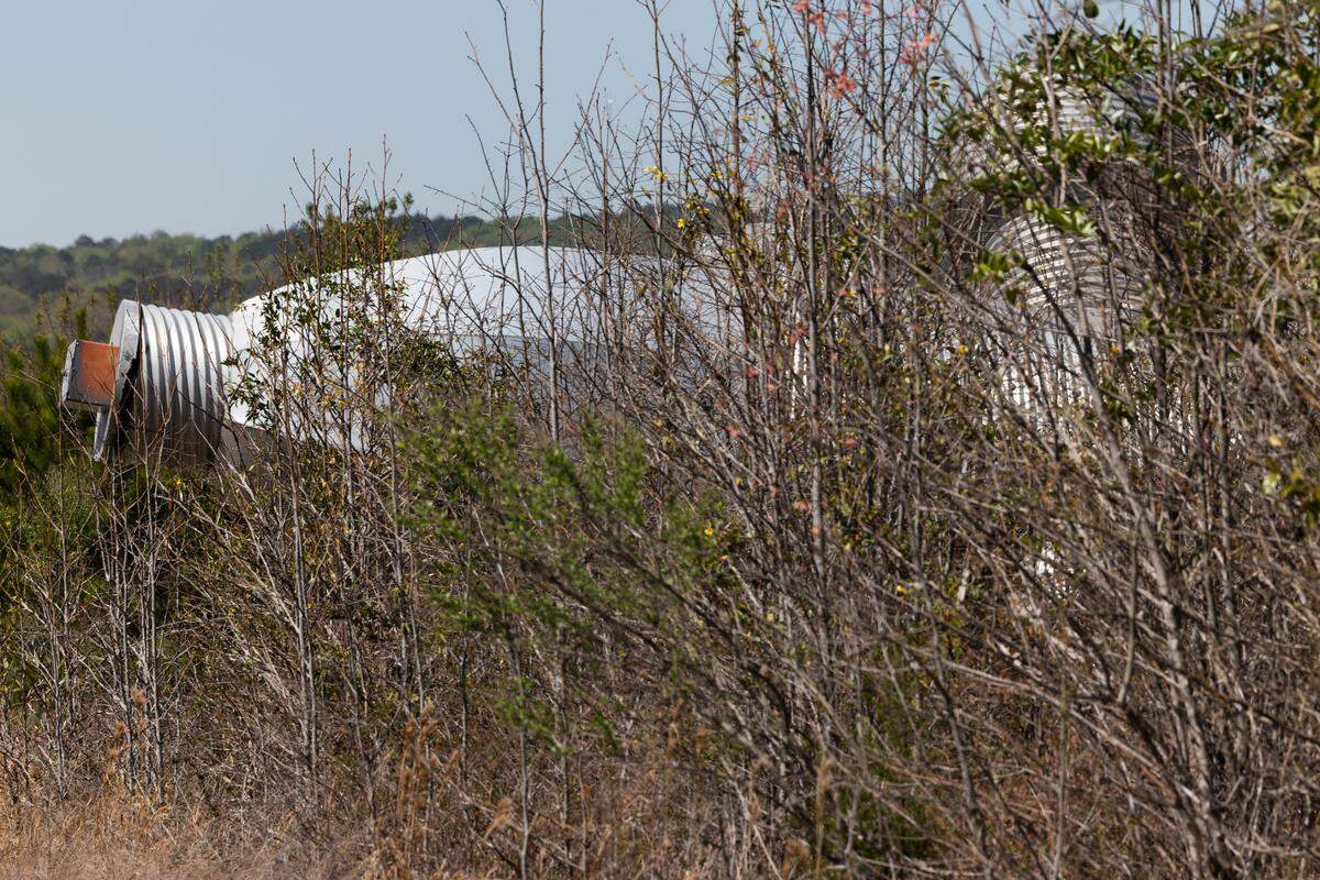 Busted Plug, a sculpture by Columbia artist Blue Sky, lays in a field north of Columbia on Wednesday, March 26, 2025. The 40-foot sculpture was installed in downtown Columbia until 2023.